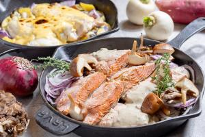 a pan of food with fish and vegetables on a table at La'gent Stay Shin Sapporo in Sapporo +51 photos
