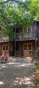 a building with two benches in front of it at Kashid Heritage Beach Resort in Kashid