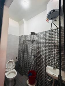 a bathroom with a toilet and a sink at Shree Ram Home Stay in Ujjain +4 photos