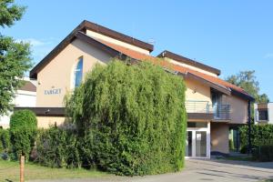 a large green bush in front of a building at Chata TARGET Senec in Senec