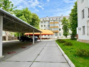 a parking lot with a car parked in front of a building at Lux Garden Appartments in Kharkiv