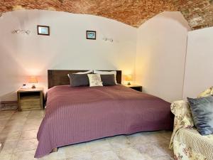 a bedroom with a bed and a couch at Vila Kralj in Podčetrtek +15 photos