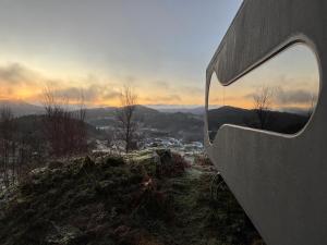 a building with a window on top of a hill at Birdbox Bergen in Bergen