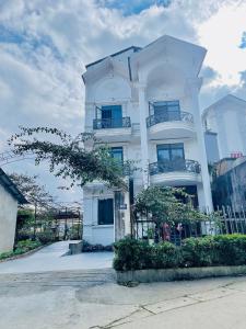 een wit gebouw met balkons erop bij The 1996 House in Lao Cai