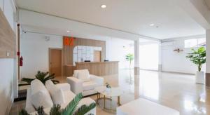 a living room with a white couch and a table at B2 Phayao Boutique & Budget Hotel in Ban Rong Ha