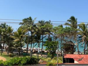 a view of the beach from the resort at Turtle Bay Resort Hikkaduwa in Hikkaduwa