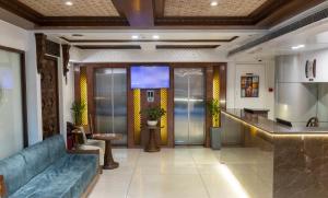 a lobby of a hotel with a blue couch at Ramee Guestline Hotel Dadar in Mumbai +48 photos