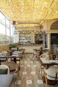 a restaurant with tables and chairs and a bar at Ramee Guestline Hotel Dadar in Mumbai
