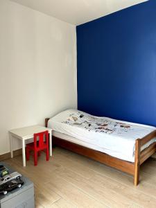 a small bedroom with a bed and a table at Kaz coco mango in Basse-Terre +37 photos