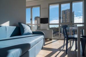 a living room with a couch and a table with a view at Darsena Ravenna Apartments in Ravenna