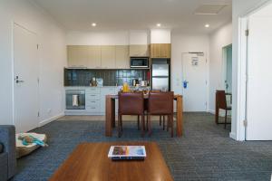 a living room and kitchen with a table and chairs at MainStay Suites Whyalla in Whyalla