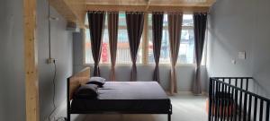 a bedroom with a bed in front of a window at Rooms in Bhowāli