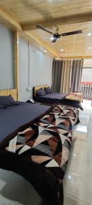 a row of beds in a room with a ceiling at Rooms in Bhowāli