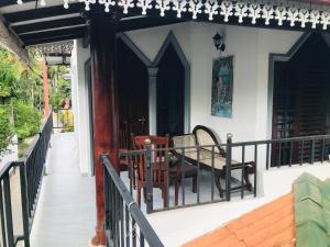a porch of a house with a table and chairs at Villa Kethmin in Talpe +47 photos