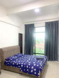 a bedroom with a bed and a large window at Mekla Hotel Studio Apartment in Gua Musang +31 photos