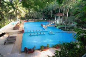 a large blue swimming pool with a gazebo at River Kwai Village Hotel in Ban Kaeng Raboet