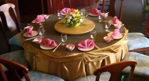 a table with pink napkins and wine glasses on it at Thai Hotel Krabi in Krabi town