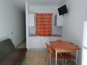 a kitchen and dining room with a table and chairs at Apartamentos Noda in Playa de Santiago +32 photos