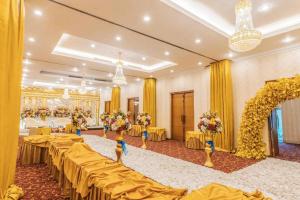 a banquet hall with tables and flowers in it at Sriwijaya Hotel in Jakarta