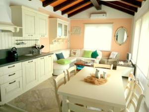 a kitchen and living room with a table and a couch at Holiday Home Slavi in Vipava