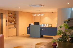 an office with a reception desk and a counter at 777Bliss Hometel in Nakhon Phanom