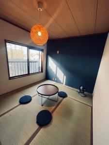 a room with a table and some blue walls at 宿えんがわーおもや in Tokorozawa