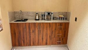a kitchen with a counter with a coffee maker on it at Bait Falaj Al Misfah Hospitality in Misfāh