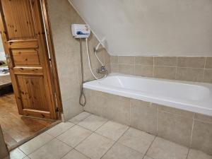 a bathroom with a bath tub in a room at חאן בשביל היער in Ta‘oz +25 photos