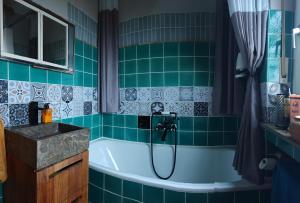 a bathroom with a tub and a sink at Ferienhaus Villa Zauberblick am Rennsteig Frankenwald in Ludwigsstadt +76 photos