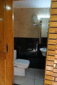 a bathroom with a toilet and a sink at skypalace hotel in Kannur
