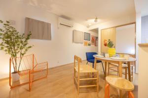 a living room with a table and chairs at Nagoya Hanezu in Nagoya
