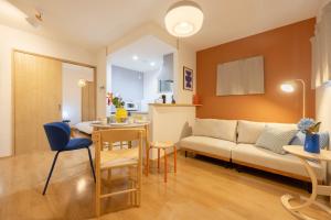 a living room with a couch and a table at Nagoya Hanezu in Nagoya +44 photos