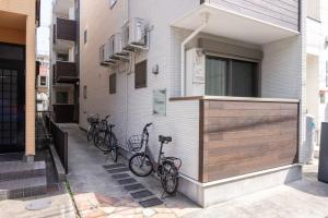 two bikes parked on the side of a building at Nagoya Hanezu in Nagoya
