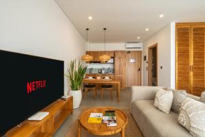 ein Wohnzimmer mit Sofa und Tisch in der Unterkunft Sunny Aparts 1 by Betterplace in Canggu