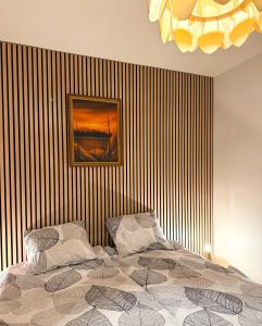 a bedroom with a bed and a painting on a striped wall at Aurora Home Rovaniemi in Rovaniemi +20 photos