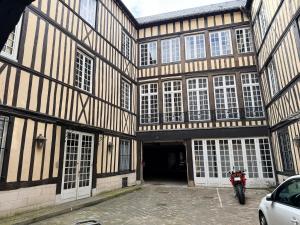 a building with a motorcycle parked in front of it at Appartement cosy et charme - 347 in Rouen