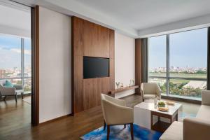 un soggiorno con televisione, tavolo e sedie di Crowne Plaza Phnom Penh by IHG a Phnom Penh Altre 125 foto