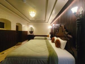 a bedroom with two beds in a room at Shree Jyotirlinga Heritage INN in Kolhapur
