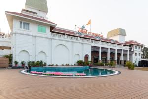 a building with a pool in front of it at JALSA HOTEL & BANQUETS,Indore in Indore