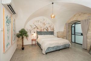 a bedroom with a bed with a painting on the wall at Moses Luxury apartments 36 a in Safed