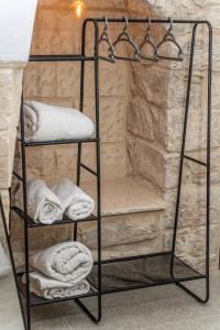 a towel rack with towels on it in a bathroom at Moses Luxury apartments 36 a in Safed