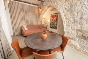 a living room with a table and chairs and a couch at Moses Luxury apartments 36 a in Safed +9 photos