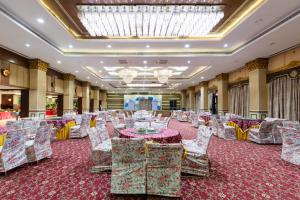 a banquet hall with chairs and tables and a chandelier at JALSA HOTEL & BANQUETS,Indore in Indore +87 photos