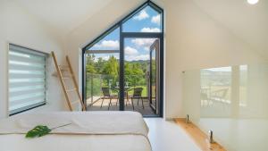 カピョンにあるGapyeong meong Valley pensionのベッドと大きな窓のある寝室