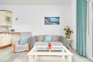 een woonkamer met een bank en een salontafel bij Apto 3 Almoraide Suites in Nerja