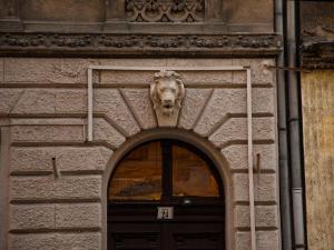 a lion head over the door of a building at Keleti Apartments in Budapest