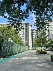 an empty street in front of a large building at Aventura Presidential Suite at SMDC Charm Residences in Manila +23 photos