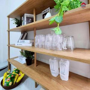 a shelf with glasses and other items on it at Aqua pool villa in Ban Nong Thale