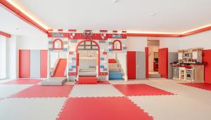 a room with a kitchen with red and white at Goseong Belossi Ayajin Kids Poolvilla in Goseong