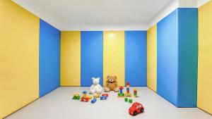 two stuffed animals sitting in a room with toys at Goseong Belossi Ayajin Kids Poolvilla in Goseong